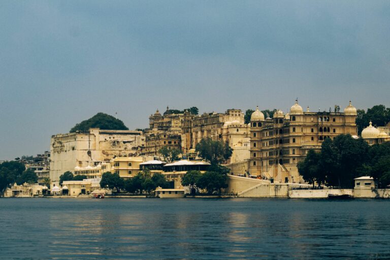 Stunning view of Udaipur's City Palace reflecting on Lake Pichola, Rajasthan.